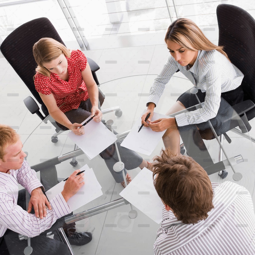 demo-attachment-458-four-businesspeople-in-a-boardroom-with-paperwork-PC4V8H4